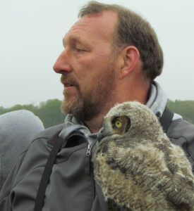 Photograph of David REussell with an owl